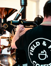 Back of a barista making coffee
