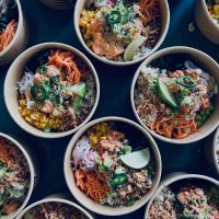 Several Poké Bowls laid out on table
