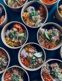 Several Poké Bowls laid out on table
